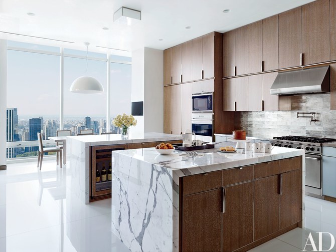 Kitchen with two matching calacatta marble islands