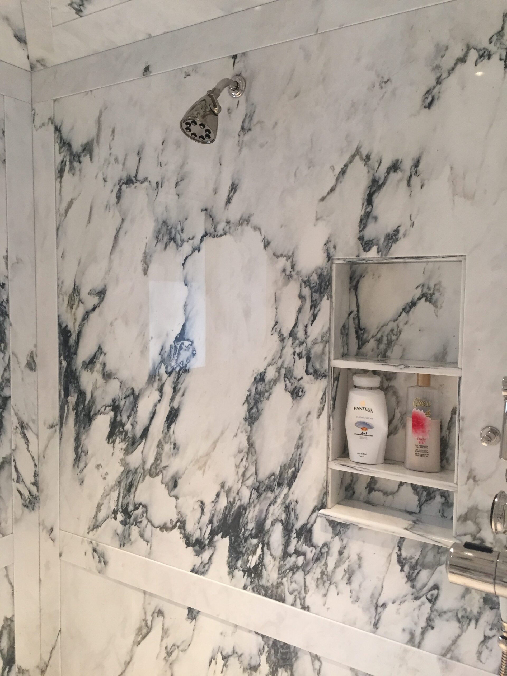 Paneled shower walls in paonazzo white marble