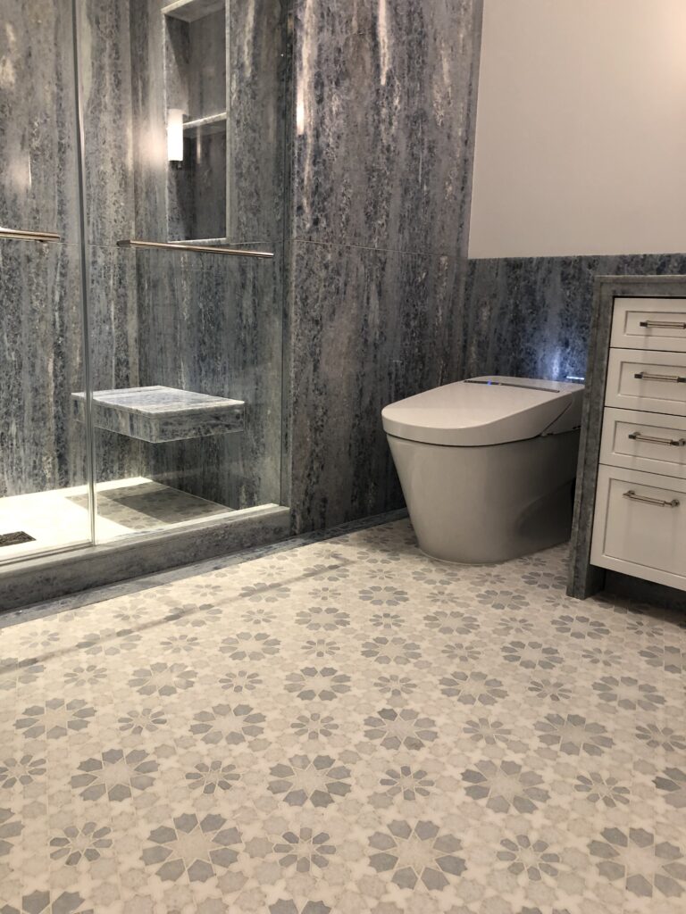 Bathroom in blue quartz slab with custom mosaic floor