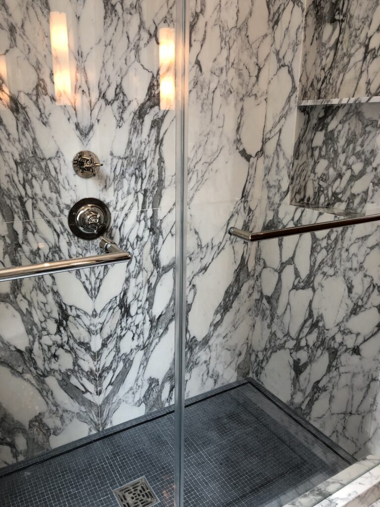 His bathroom shower in arabescato calacatta marble slab