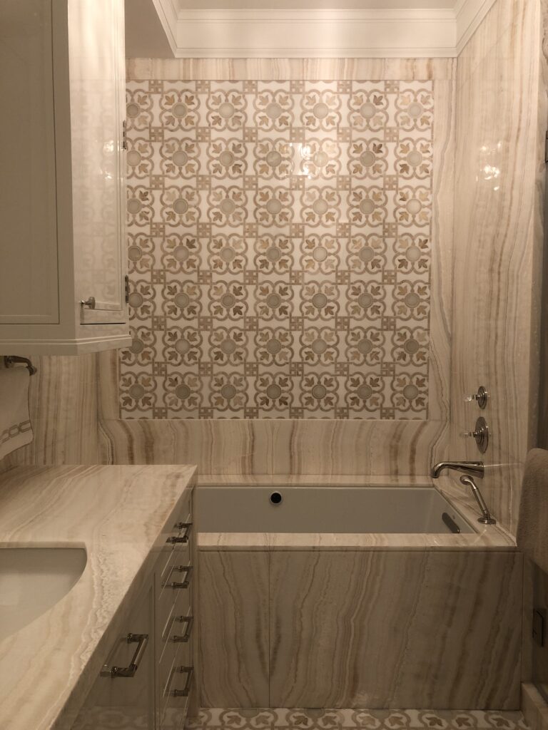 Her Bathroom in Ivory onyx slab and custom mosaic