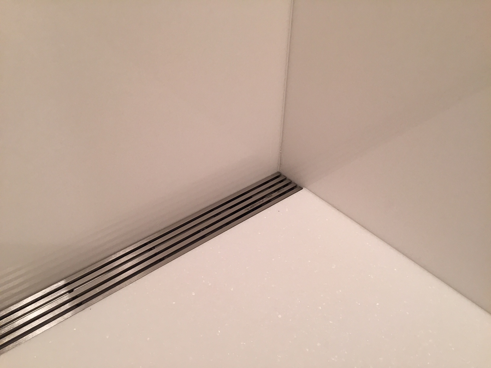 Master bathroom shower in white thassos slab with linear drain