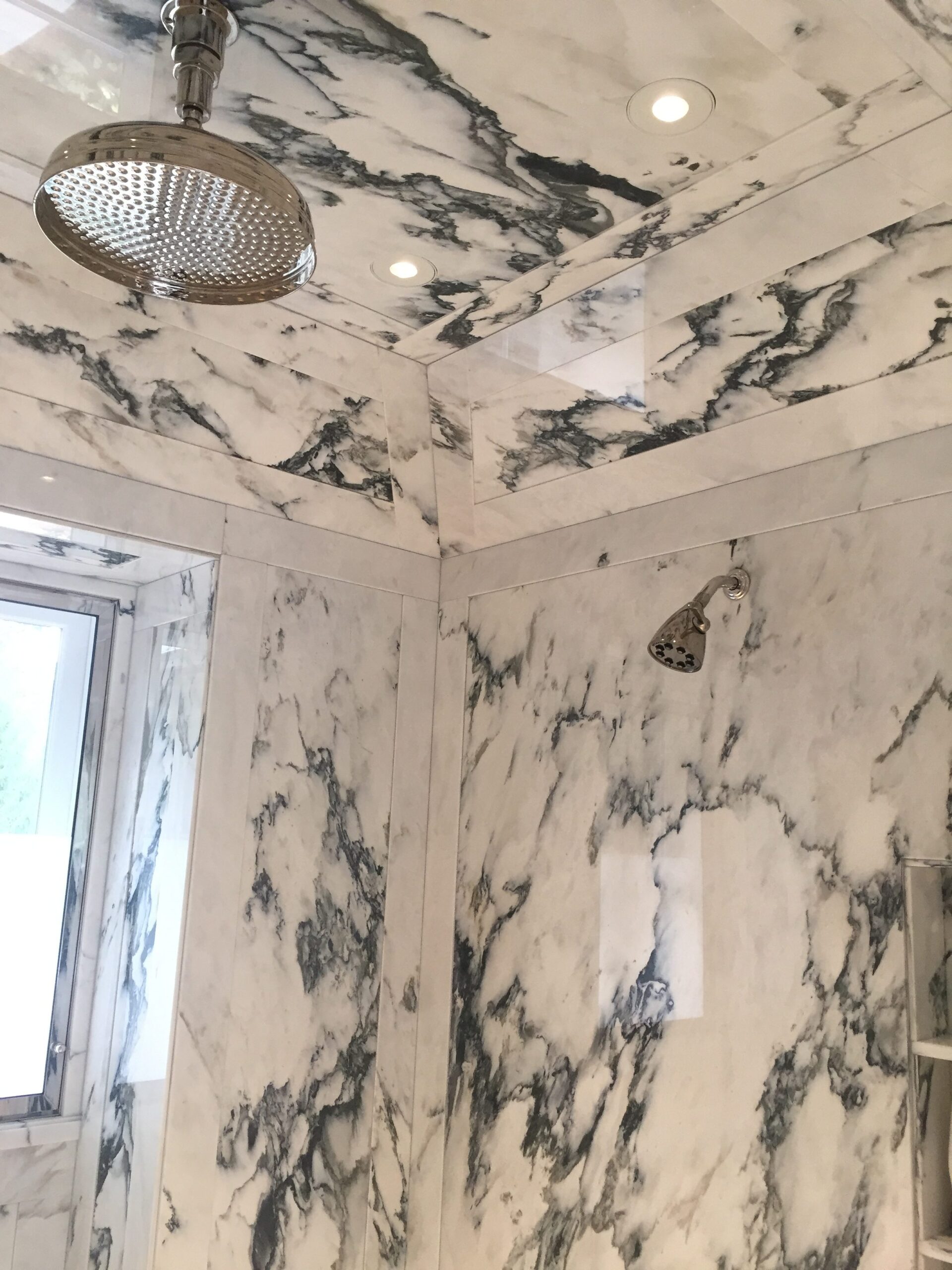 Paneled shower walls and ceiling in paonazzo white marble