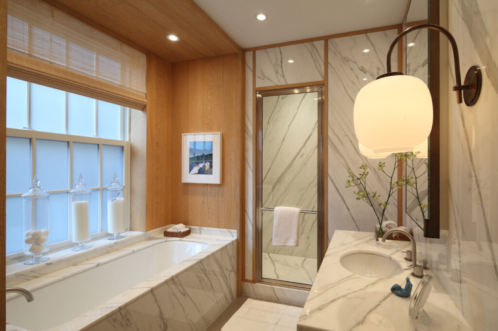 Calacatta marble with wood paneled primary bathroom