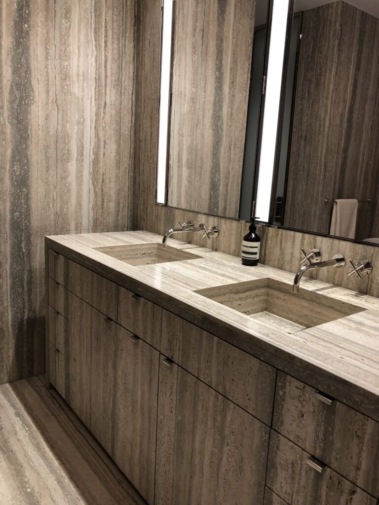 Primary bathroom vanity laminated in silver travertine