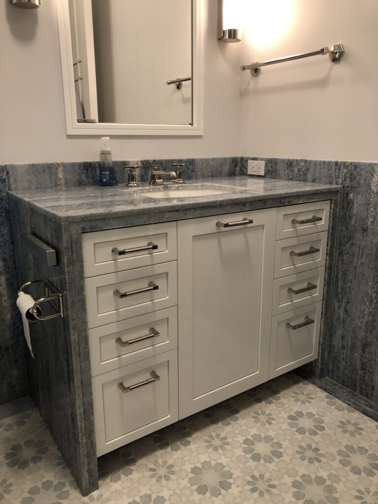 Bathroom vanity in blue quartz slab with custom mosaic floor