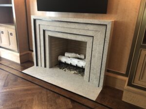 Library custom limestone and bronze fireplace mantel